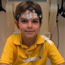 Boy with sensor pads on his head