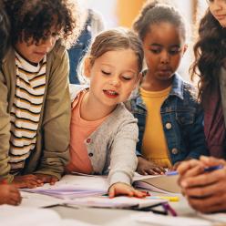 A group of young kids working on a project in class.