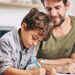 Man helping boy with his homework