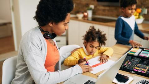 Mother homeschooling two kids