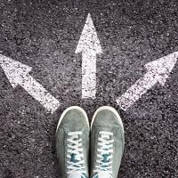 Tennis shoes with chalk arrows pointing away from them