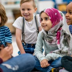 Teacher reading to kids on the floor